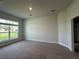 Spacious bedroom with neutral-colored walls, carpet, and large window for plenty of natural light at 13418 Sw 60Th Court Rd, Ocala, FL 34473