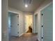 Hallway with neutral walls, plush carpet, and doors leading to various rooms at 13418 Sw 60Th Court Rd, Ocala, FL 34473