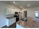 Modern kitchen boasting stainless steel appliances, an island and white cabinetry at 13418 Sw 60Th Court Rd, Ocala, FL 34473