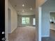 Bright living room featuring neutral carpet, recessed lighting and a large window at 13418 Sw 60Th Court Rd, Ocala, FL 34473