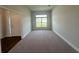 Living room with carpeted floors and natural light streaming in through a large window at 13418 Sw 60Th Court Rd, Ocala, FL 34473