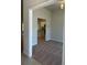 View of the living room showing neutral walls, carpet flooring and entry to kitchen area at 13418 Sw 60Th Court Rd, Ocala, FL 34473