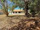 View of the backyard with its well-maintained lawn and mature trees providing shade at 13718 Sw 40Th Cir, Ocala, FL 34473