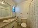 Bathroom featuring a sink, toilet, and shower with patterned shower curtain at 13718 Sw 40Th Cir, Ocala, FL 34473