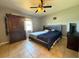 Bedroom with tile floors, ceiling fan, large wardrobe, and a modern bedframe at 13718 Sw 40Th Cir, Ocala, FL 34473