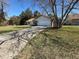 Home's exterior featuring a spacious driveway, attached garage, and well-kept lawn at 13718 Sw 40Th Cir, Ocala, FL 34473