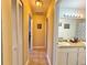 Hallway that connects to the bathroom, which features tile floors and a vanity with dual sinks at 13718 Sw 40Th Cir, Ocala, FL 34473