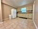 Bright kitchen with white cabinets and tile flooring for easy maintenance at 13718 Sw 40Th Cir, Ocala, FL 34473