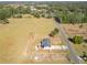 A high-altitude aerial perspective reveals the home's location amidst a vast rural expanse and road at 13800 Se 80Th Ave, Summerfield, FL 34491