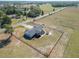 A distant aerial view showing the home and its fenced yard within a sprawling rural landscape at 13800 Se 80Th Ave, Summerfield, FL 34491