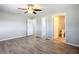 Spacious bedroom showcasing new hardwood flooring, ceiling fan and multiple closet doors at 13800 Se 80Th Ave, Summerfield, FL 34491