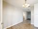 Bright living room with a chandelier and wood-look flooring leading to the bathroom at 13800 Se 80Th Ave, Summerfield, FL 34491