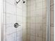 Close up of shower with new marble tile and shower head at 13800 Se 80Th Ave, Summerfield, FL 34491