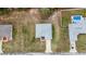 Aerial shot showcases the home's well-maintained yard and proximity to a sparkling pool at 1482 Ne 160Th Pl, Citra, FL 32113