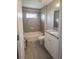 Bathroom featuring a gray tiled shower-tub combo and vanity with granite countertop at 1482 Ne 160Th Pl, Citra, FL 32113