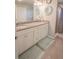 Bathroom featuring dual sinks, granite countertops, and a shower with tiled walls at 1482 Ne 160Th Pl, Citra, FL 32113