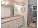 Elegant bathroom with double vanity, granite countertops, and a tiled shower at 1482 Ne 160Th Pl, Citra, FL 32113