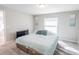 Bedroom with neutral walls, carpet, and natural light streaming through a window at 1482 Ne 160Th Pl, Citra, FL 32113