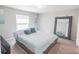 Comfortable bedroom featuring a large bed with plush pillows and a full-length mirror at 1482 Ne 160Th Pl, Citra, FL 32113