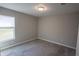 Empty bedroom features plush gray carpet, a window with blinds, and neutral walls at 1482 Ne 160Th Pl, Citra, FL 32113