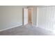 Bedroom with plush gray carpet, white closet doors, and neutral walls at 1482 Ne 160Th Pl, Citra, FL 32113