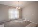 Bright dining room with decorative chandelier and large window for natural light at 1482 Ne 160Th Pl, Citra, FL 32113