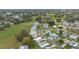 Aerial view of residential neighborhood with manicured lawns and golf course in the distance at 1541 Hillcrest Dr, Lady Lake, FL 32159