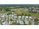 Aerial view of residential neighborhood with manicured lawns, landscaping and golf course in the distance at 1541 Hillcrest Dr, Lady Lake, FL 32159