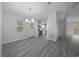 Bright dining room with modern chandelier, opening to the kitchen at 1541 Hillcrest Dr, Lady Lake, FL 32159