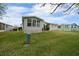 Side view of a home with a well-manicured lawn at 1541 Hillcrest Dr, Lady Lake, FL 32159