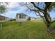 Side view of a home with a well-manicured lawn at 1541 Hillcrest Dr, Lady Lake, FL 32159