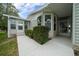 Home exterior featuring a covered entrance and manicured hedges at 1541 Hillcrest Dr, Lady Lake, FL 32159