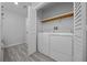 Practical laundry room with washer, dryer, storage shelf and bi-fold door at 1541 Hillcrest Dr, Lady Lake, FL 32159