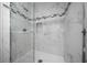 Bathroom shower featuring marble tiles, glass enclosure, and sleek fixtures at 1541 Hillcrest Dr, Lady Lake, FL 32159