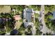 Stunning aerial view of property showcasing lush landscaping, fountain feature, multiple structures, and ample parking space at 1655 Sunnyside Dr, Maitland, FL 32751