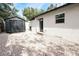 Backyard with a storage shed, door, and a mix of fencing and stone ground cover at 1655 Sunnyside Dr, Maitland, FL 32751