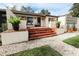 Charming home featuring a brick staircase with a white facade, landscaping, and a stone walkway at 1655 Sunnyside Dr, Maitland, FL 32751