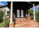 Inviting front porch featuring tiled steps and decorative potted plants at 1655 Sunnyside Dr, Maitland, FL 32751