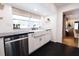 Bright kitchenette with stainless steel dishwasher, farmhouse sink, and black countertops at 1655 Sunnyside Dr, Maitland, FL 32751