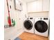 Laundry room with white washer and dryer, and white storage cabinets at 1655 Sunnyside Dr, Maitland, FL 32751