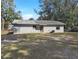 Back exterior view of home, showing yard and architecture at 18 Juniper Pass Crse, Ocala, FL 34480