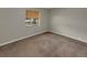 Bedroom featuring a large window and neutral carpeting at 18 Juniper Pass Crse, Ocala, FL 34480