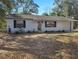 A single story residence featuring black shuttered windows and a well-maintained yard at 18 Juniper Pass Crse, Ocala, FL 34480