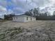 The house sits in a spacious backyard with sandy soil at 19 Bay Court Pass, Ocklawaha, FL 32179