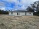 Back of a one-story house and newly poured patio at 19 Bay Court Pass, Ocklawaha, FL 32179