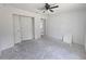 Bright bedroom with a ceiling fan, closet, and doorway to another room, offering a versatile living space at 19 Bay Court Pass, Ocklawaha, FL 32179