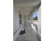 Covered entryway featuring gray trim and white stucco walls at 19 Bay Court Pass, Ocklawaha, FL 32179