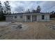 New construction home featuring a light grey stucco facade, a one car garage, and a covered entryway at 19 Bay Court Pass, Ocklawaha, FL 32179