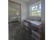 Bright kitchen featuring white cabinets, open layout and natural light streaming through a window at 19 Bay Court Pass, Ocklawaha, FL 32179