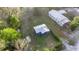 Aerial view shows the cozy home and grassy lot in a peaceful setting at 21055 Highway 441 N, Micanopy, FL 32667